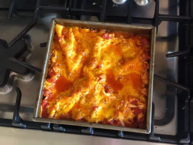 Baked Mexican lasagna sitting on stove top