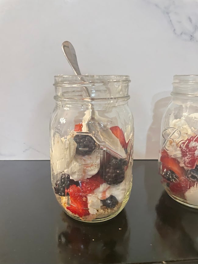 finished layered cheesecake in a jar ready to eat