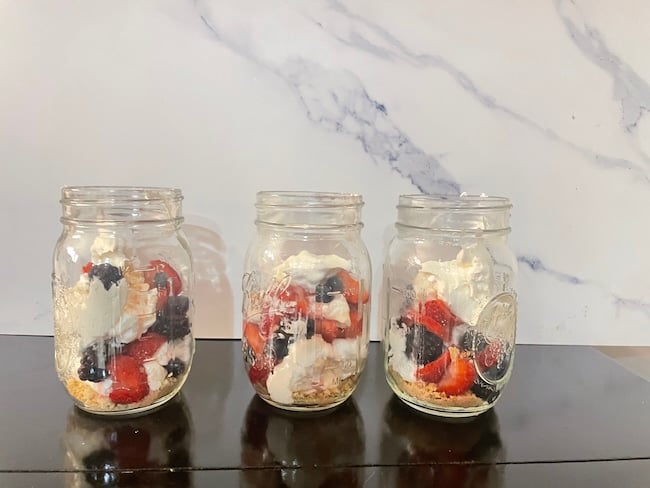 finished layered cheesecake in a jars