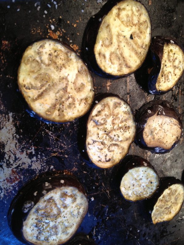 eggplant sliced being salted on a cookie sheet