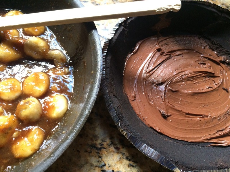 Bananas Foster  in a pan next to a chocolate lined crust