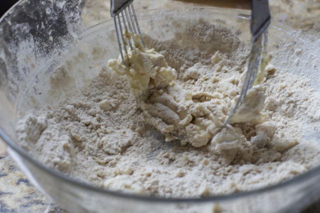 making the apple pie crumb topping in a bowl