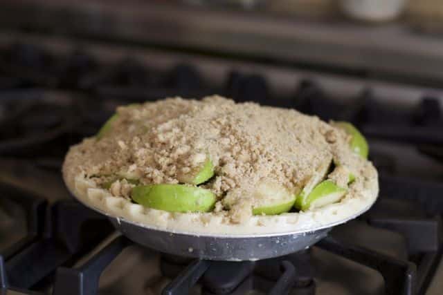 french apple pie filled but uncooked with topping on