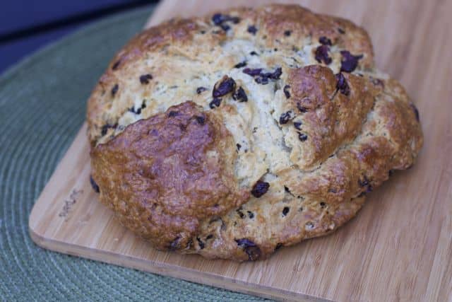 Easy Irish Soda Bread baked on a cutting board on top of green placemat