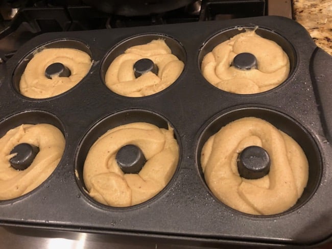 baked apple cider donuts batter in a doughnut pan