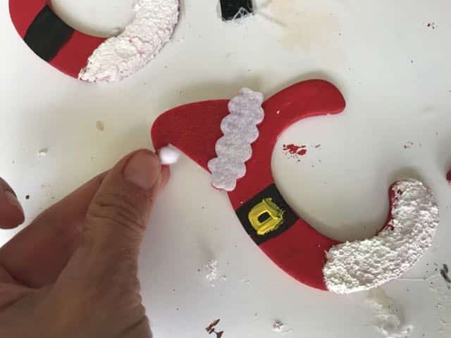adding a sticker santa hat on letter c ornament