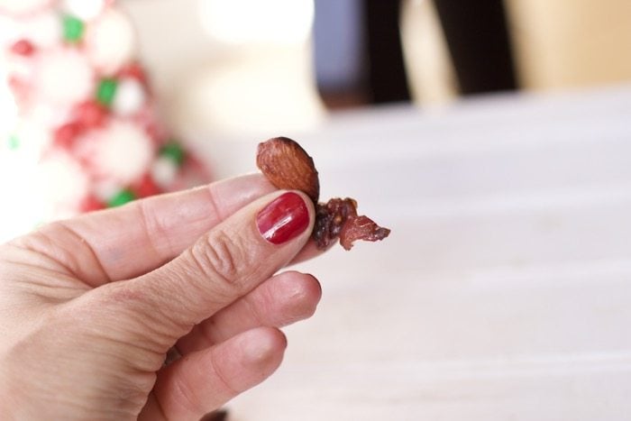 holding up a few glazed almonds with bacon