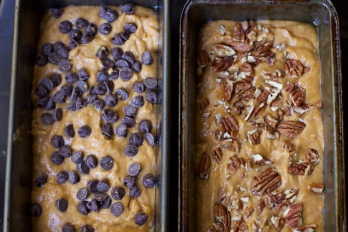 2 pans of unbaked banana pumpkin quick bread topped with chocolate chips and nuts