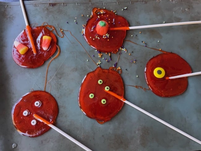 adding decorations to homemade lollipops