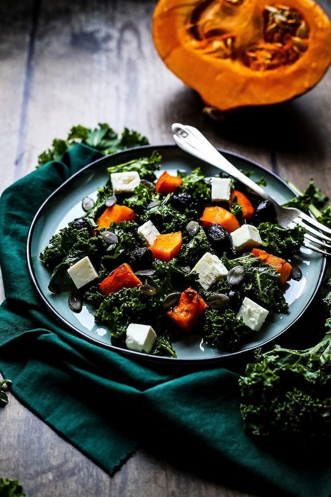 Kale Pumpkin Salad With Feta And Pesto Dressing Happy Kitchen on blue plate